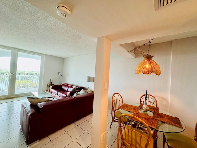 tiled living room featuring a textured ceiling