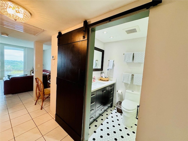 bathroom featuring vanity, tile floors, and toilet