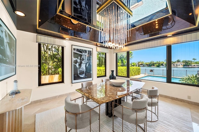 tiled dining area featuring a water view