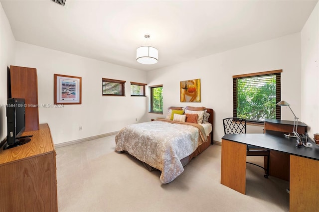 bedroom featuring light colored carpet