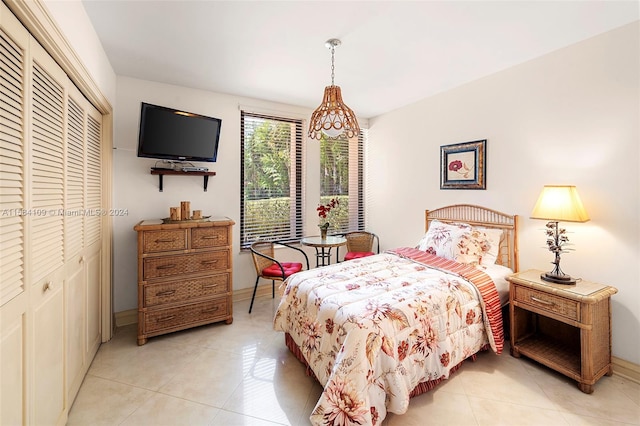 tiled bedroom featuring a closet