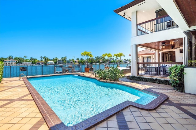 view of swimming pool with a patio area and a water view