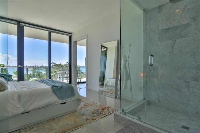 bedroom featuring multiple windows and expansive windows