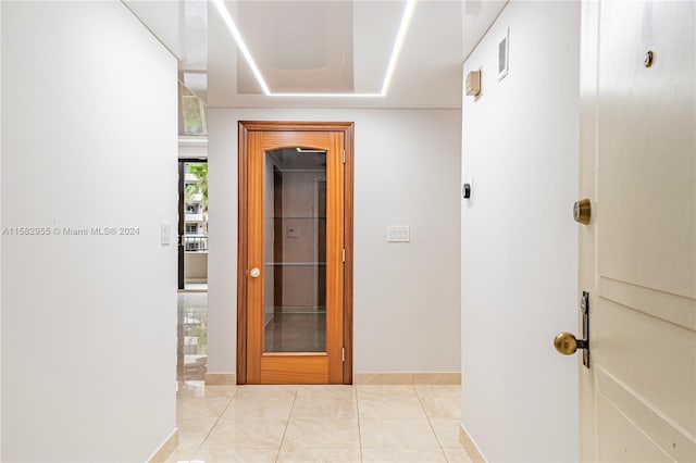 corridor with light tile floors