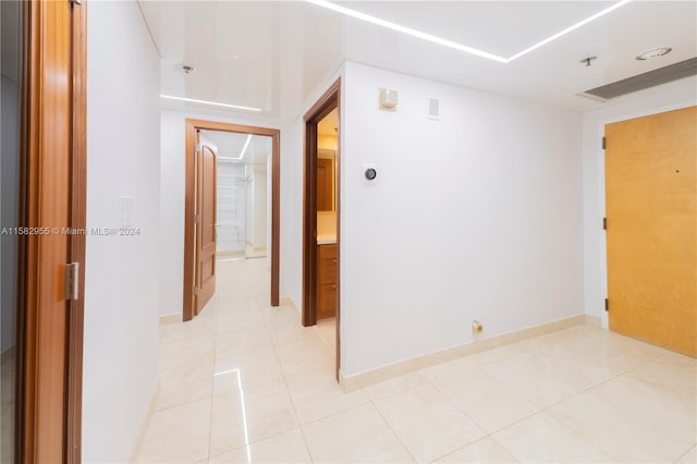 hall featuring light tile flooring