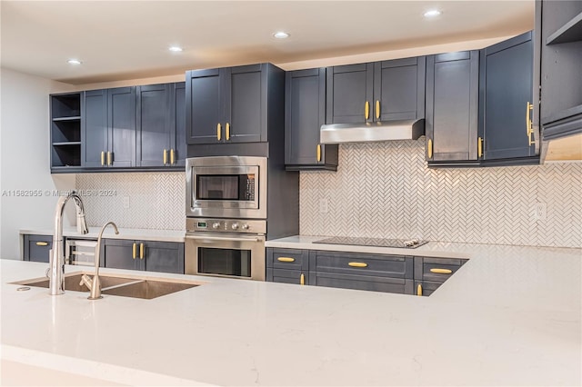 kitchen with stainless steel appliances, backsplash, and sink