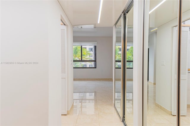 hallway featuring light tile flooring