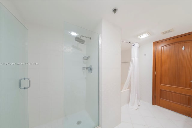 bathroom with a shower with door