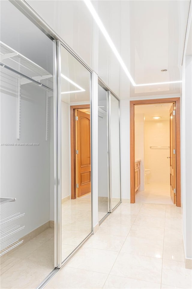 corridor with light tile floors