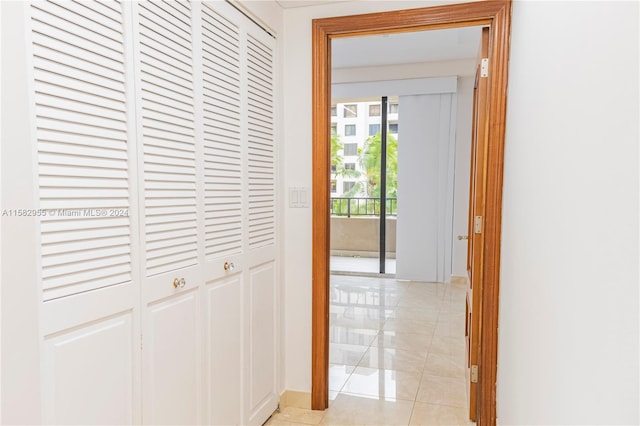 hall featuring light tile flooring