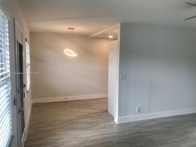 unfurnished room with a wealth of natural light, ceiling fan, and hardwood / wood-style flooring