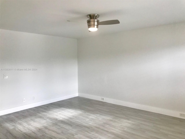 empty room featuring ceiling fan and hardwood / wood-style flooring