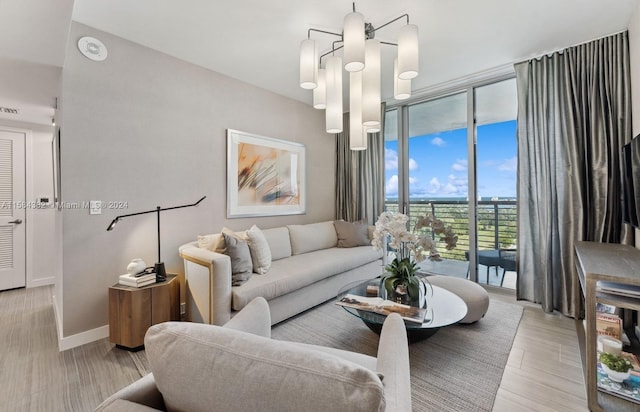 living room featuring a notable chandelier and light hardwood / wood-style floors