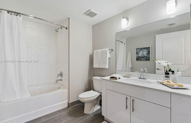 full bathroom featuring vanity, toilet, and shower / tub combo