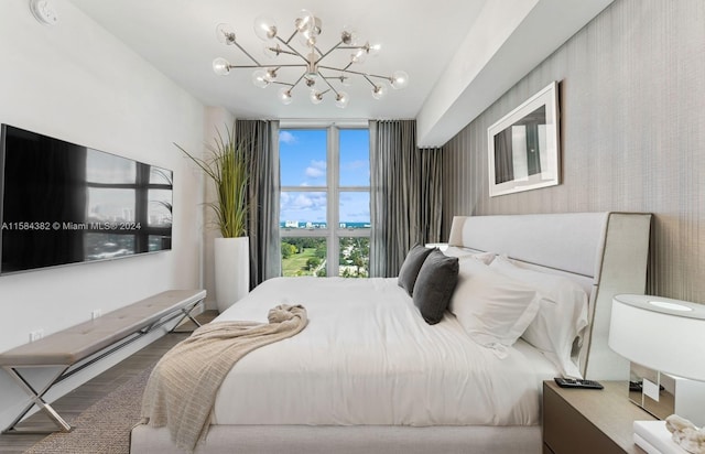 bedroom with a chandelier and hardwood / wood-style floors