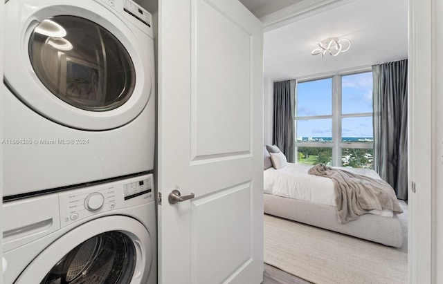 laundry area featuring stacked washing maching and dryer