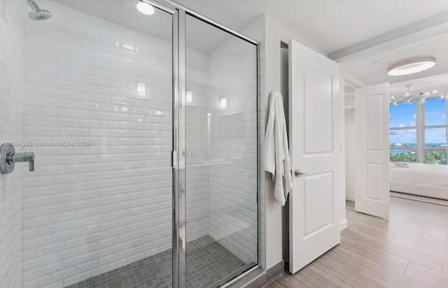 bathroom featuring a chandelier and walk in shower