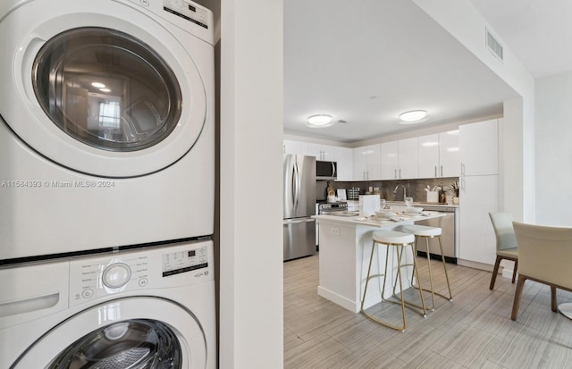 washroom with stacked washer / dryer