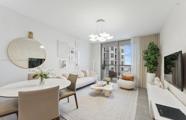 interior space with light hardwood / wood-style flooring, expansive windows, and a notable chandelier