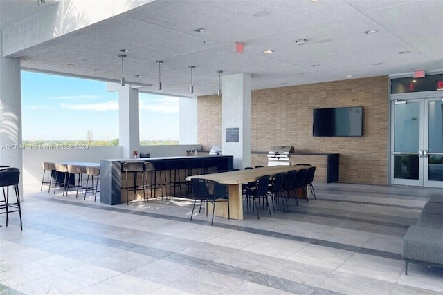 view of patio with a grill, french doors, and a bar