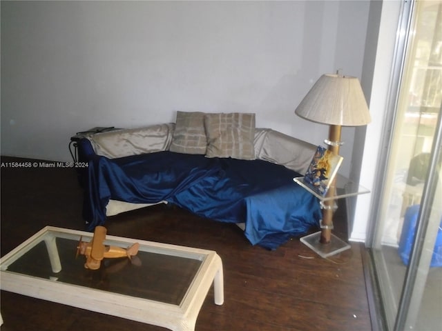 bedroom with multiple windows and dark hardwood / wood-style flooring