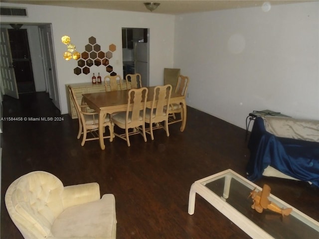 dining space with dark hardwood / wood-style flooring