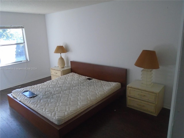 bedroom featuring dark wood-type flooring