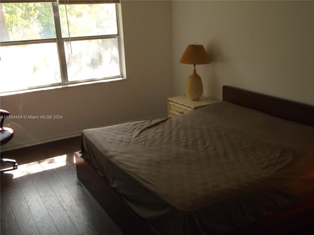 bedroom featuring dark hardwood / wood-style flooring