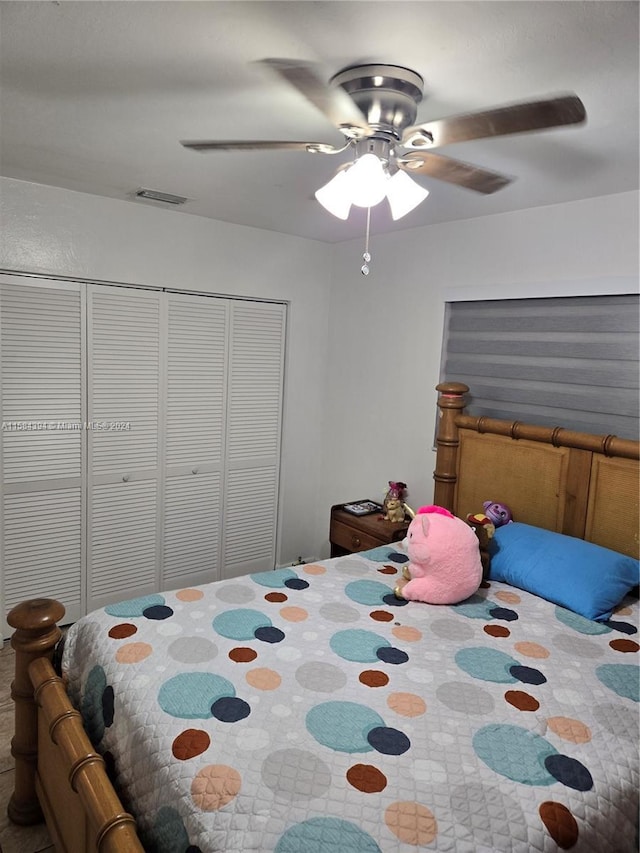 bedroom with ceiling fan and a closet