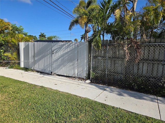 view of gate featuring a yard