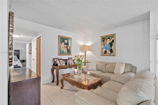 living room with a textured ceiling and light tile patterned floors