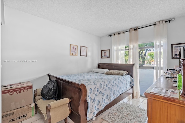 tiled bedroom with a textured ceiling