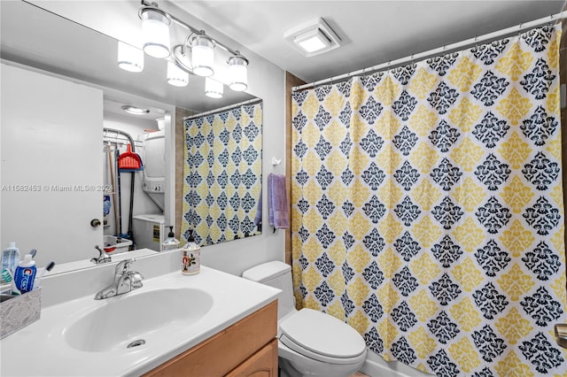 bathroom featuring curtained shower, toilet, and vanity