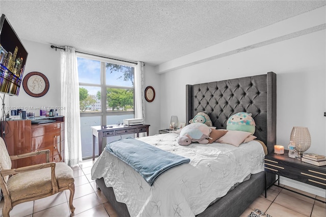 bedroom with light tile patterned floors and a textured ceiling