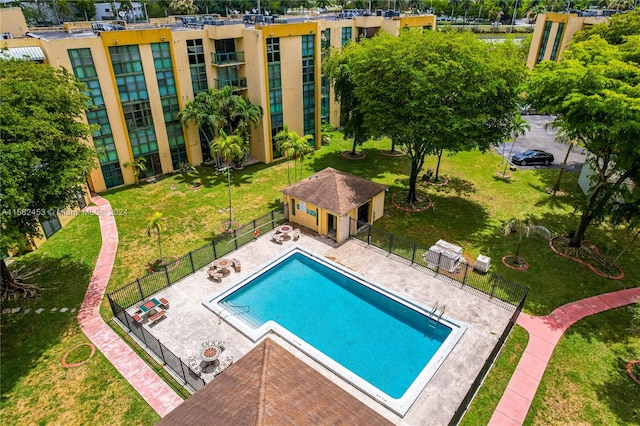 view of pool featuring a patio area and a yard