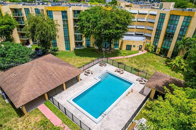 view of swimming pool featuring a lawn and a patio