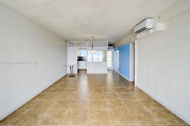 interior space with a textured ceiling and a wall mounted air conditioner