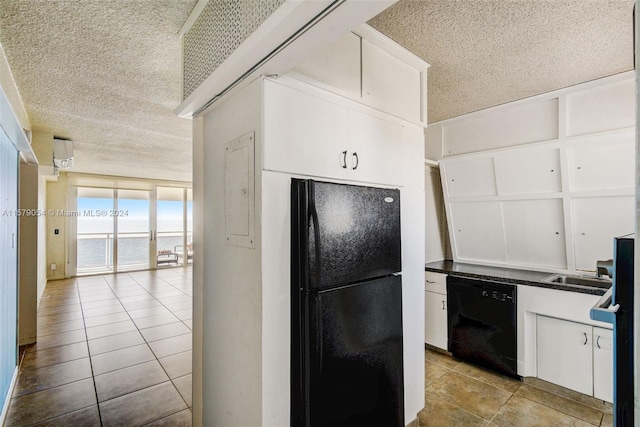 kitchen featuring a textured ceiling, white cabinets, black appliances, and light tile floors