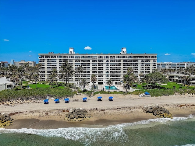 view of property featuring a view of the beach and a water view