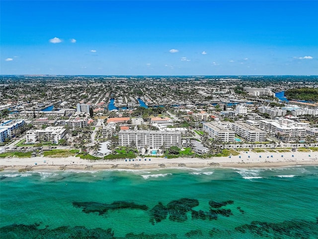 birds eye view of property with a beach view and a water view