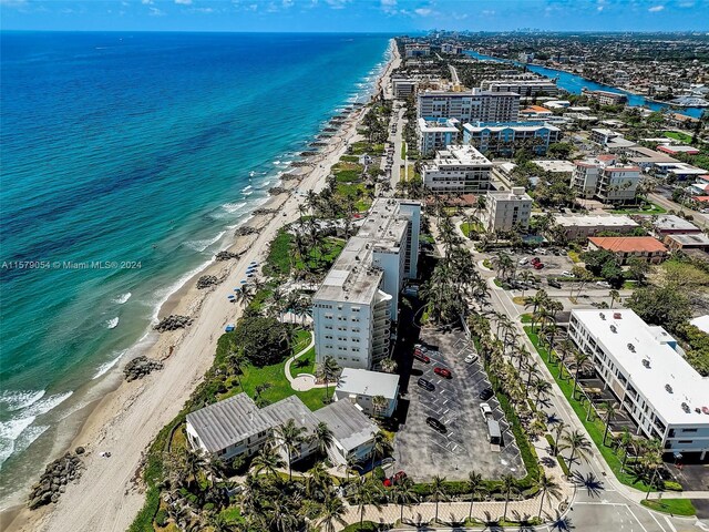 bird's eye view featuring a water view and a view of the beach