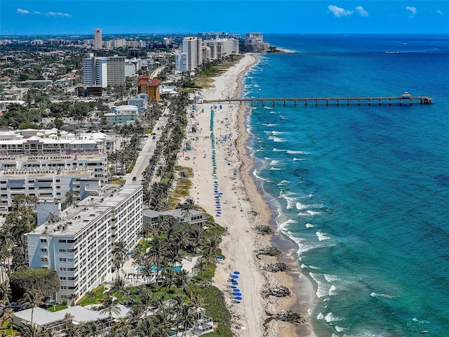 drone / aerial view with a beach view and a water view