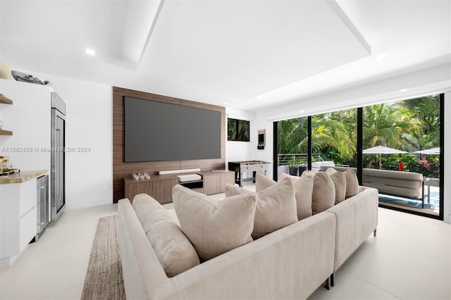 tiled living room with a tray ceiling