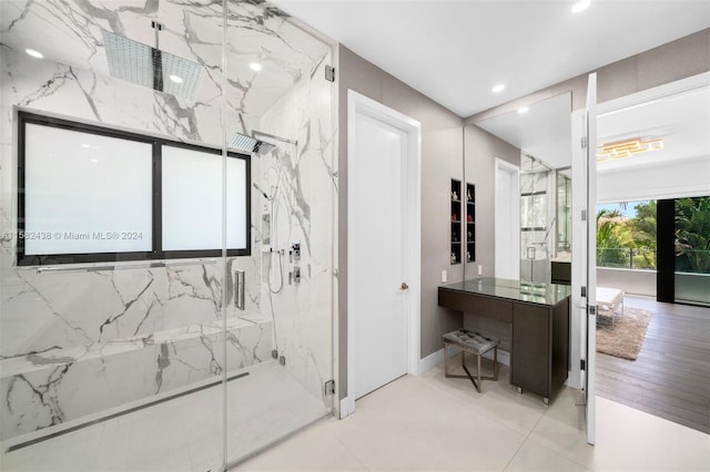 bathroom with tile patterned floors, vanity, and walk in shower