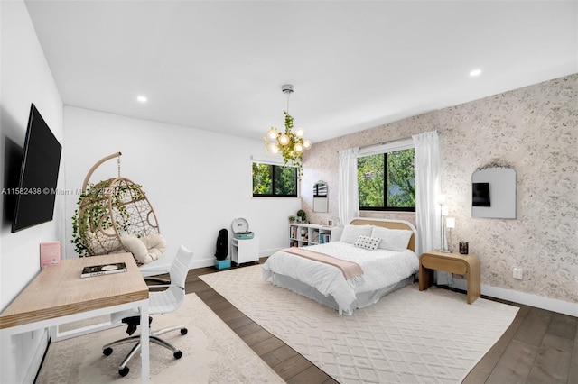 bedroom featuring hardwood / wood-style flooring and a notable chandelier