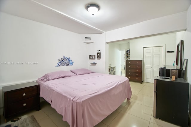 tiled bedroom featuring a closet