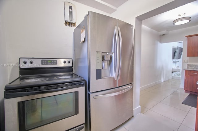 kitchen with light tile patterned floors and stainless steel appliances