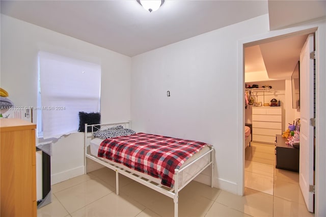 bedroom featuring light tile patterned flooring