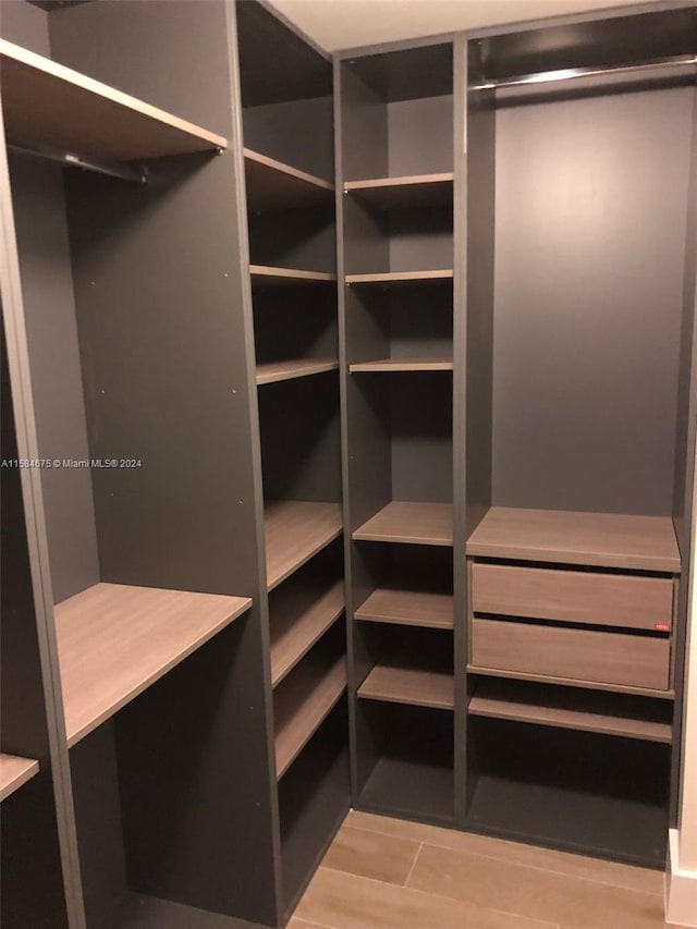 walk in closet featuring light hardwood / wood-style flooring