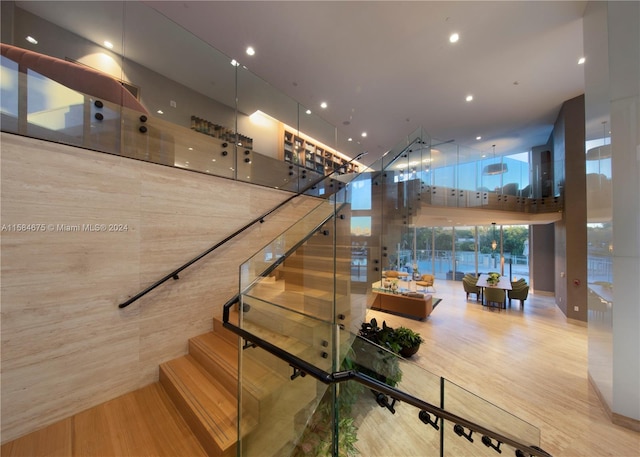 stairway with light hardwood / wood-style flooring